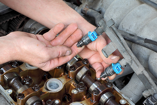 What Happens to Engine Performance When Fuel Injectors Get Clogged and Stop Spraying Properly?
